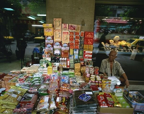 Elderly street trader with his stall in Bangkok