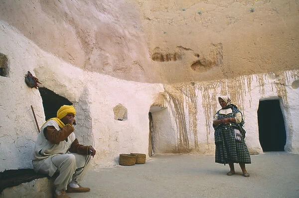 20035638. TUNISIA Matmata Couple at entrance to cave homes