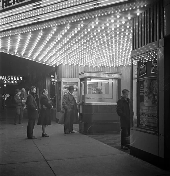 MOVIE THEATRE, 1941. People at the box office of a movie theatre in Blue Island, Illinois