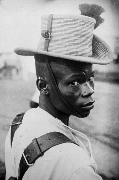 An Askari. 1930: An Askari soldier in Kenya wearing their tall-crowned
