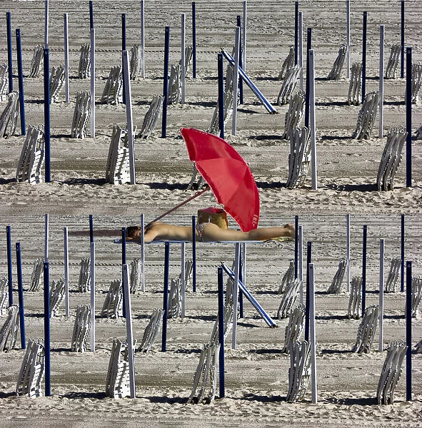 Composition of poles and chairs with red umbrella