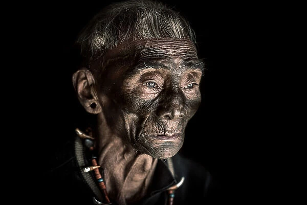 The tattooed face of a Konyak man