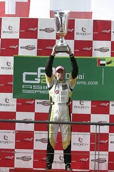 2008 GP2 Asia Series. Friday Race. Dubai. Dubai Autodrome. 11th April. Romain Grosjean (FRA, ART Grand Prix) celebrates victory on the podium. World Copyright: Alastair Staley / GP2 Series Media Service. Service ref:__MG_4845. jpg