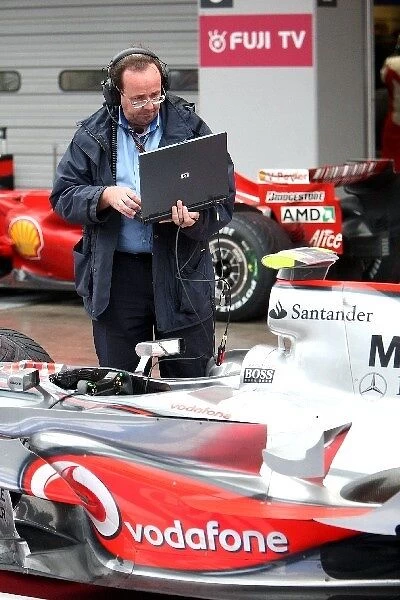 Formula One World Championship: Simon Busby FIA Software analyst checks a McLaren
