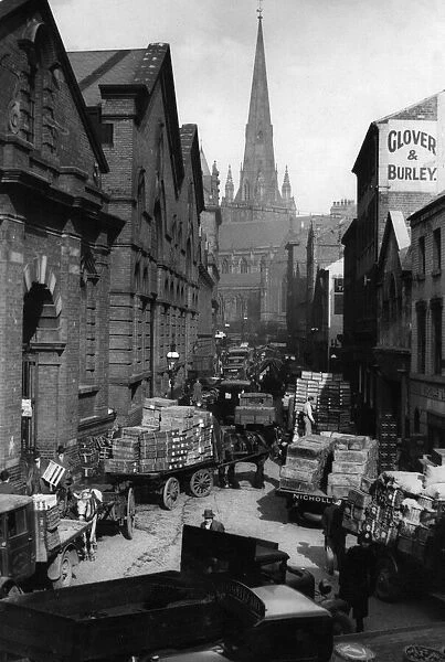 A busy market scene in Moat Lane, Birmingham, with The church of St Martin in the Bull