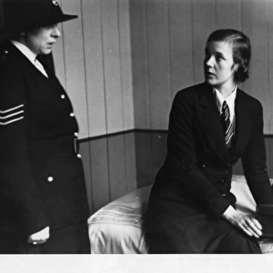 Civilian woman with woman police sergeant
