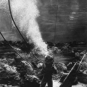 The first photograph of a diver at the bottom of the sea