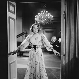 Rita Johnson wearing an evening gown designed by Dolly Tree