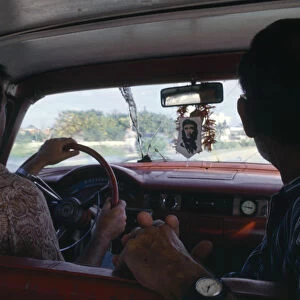 Cuba, Interior of car with image of Che Guevara hanging beneath rear view mirror