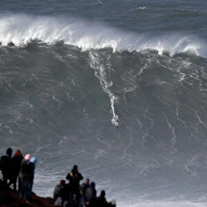 Big-wave surfer Sebastian Steudtner of Germany drops in a large wave at Praia do Norte in