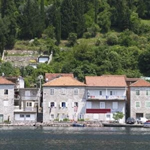 Stone houses along the water edge in Lepetani. Montenegro, Balkan, Europe