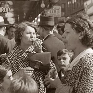 CONEY ISLAND, 1936. Women and children eating hot dog in Coney Island, Brooklyn