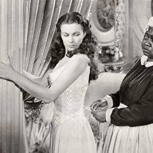 GONE WITH THE WIND, 1939. Hattie McDaniel assists Vivien Leigh while offering some unwelcomed advice