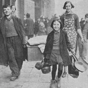 Women and children made homeless by German bombing, walking through a Liverpool street
