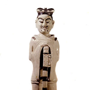 Chinese Art: white porcelain statuette has black civil guard highs leaning on its spee
