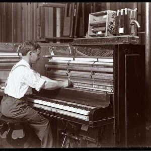 A man working in the Harrington Piano Co. factory, 1907 (silver gelatin print)