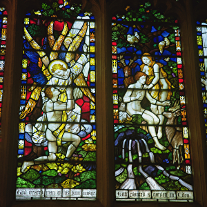 Stained glass windows depicting (LtoR) The Annunciation and Adam