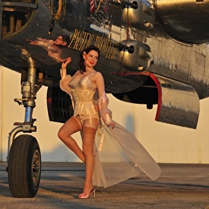 Beautiful 1940s pin-up girl standing with a B-25 bomber