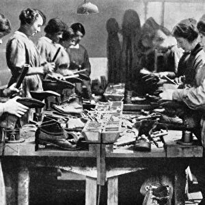 Women cobblers repairing footwear for the war effort, 1914-1918 (1936)
