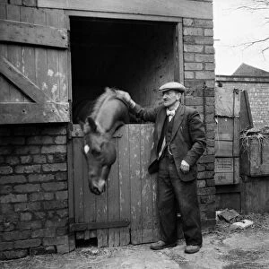 Eccentric millionaire Bob Hiddle patting his horse at his stable