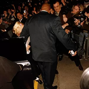 Madonna actress & singer getting out of a car with her bodyguard The Wall