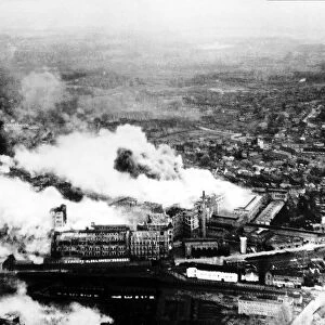 Smoke pours from The Philips radio valve works in Eidhoven Holland after a daylight raid